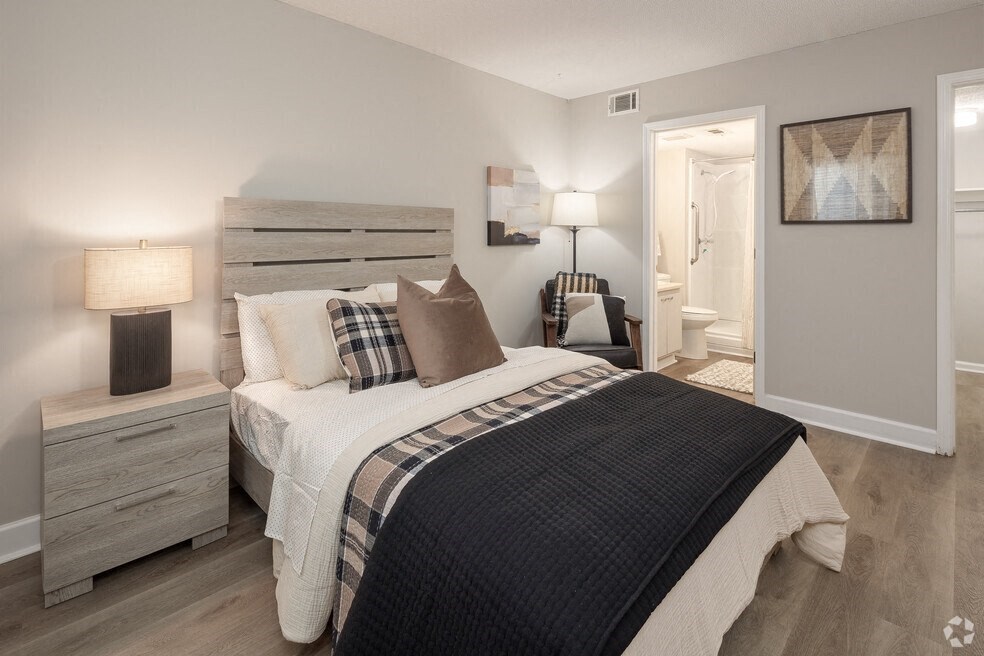 a bedroom with a bed and a door to a bathroom