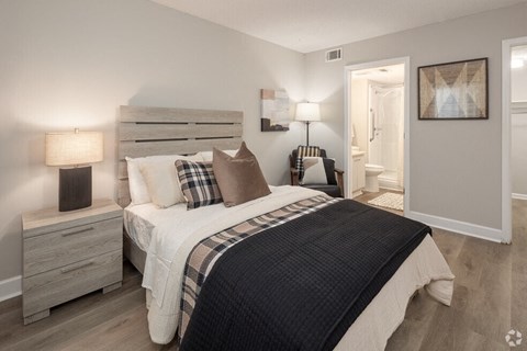 a bedroom with a bed and a door to a bathroom