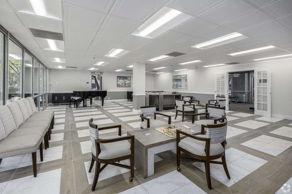 a conference room with tables and chairs and a piano