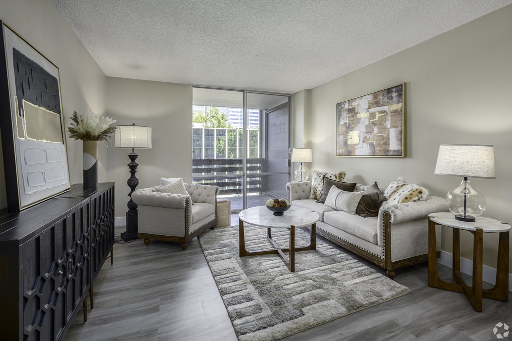 an open living room with a couch and chairs and a table