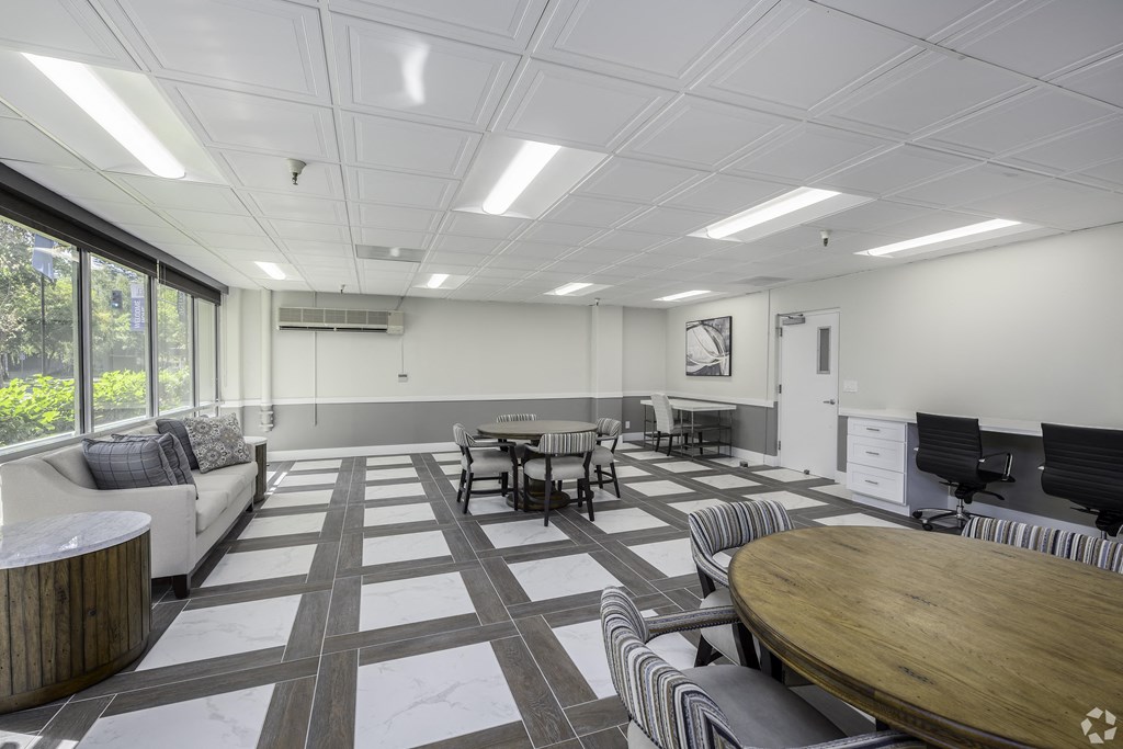 a conference room with tables and chairs and a projector screen
