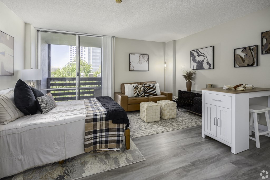 a bedroom with a bed and a large window