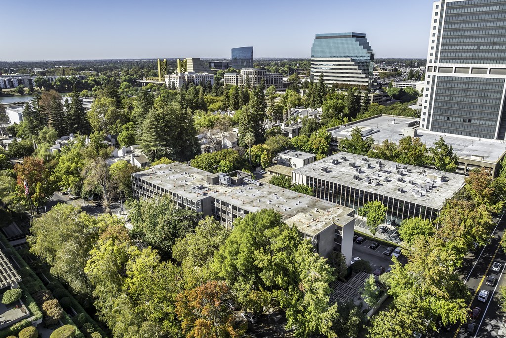 an aerial view of a city with trees and buildings