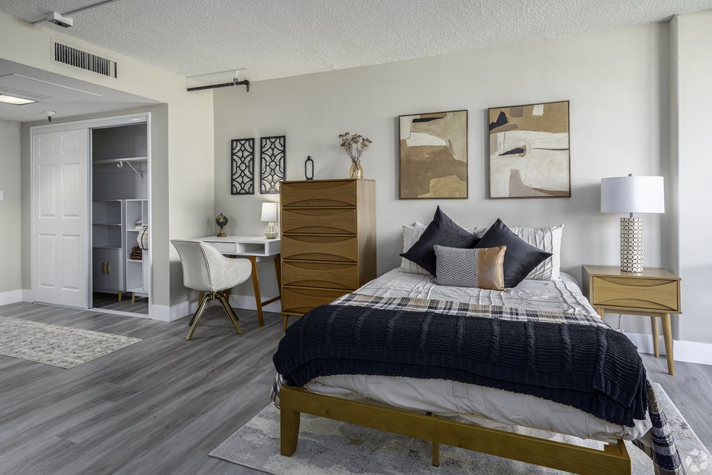 a bedroom with a bed and a desk with a chair