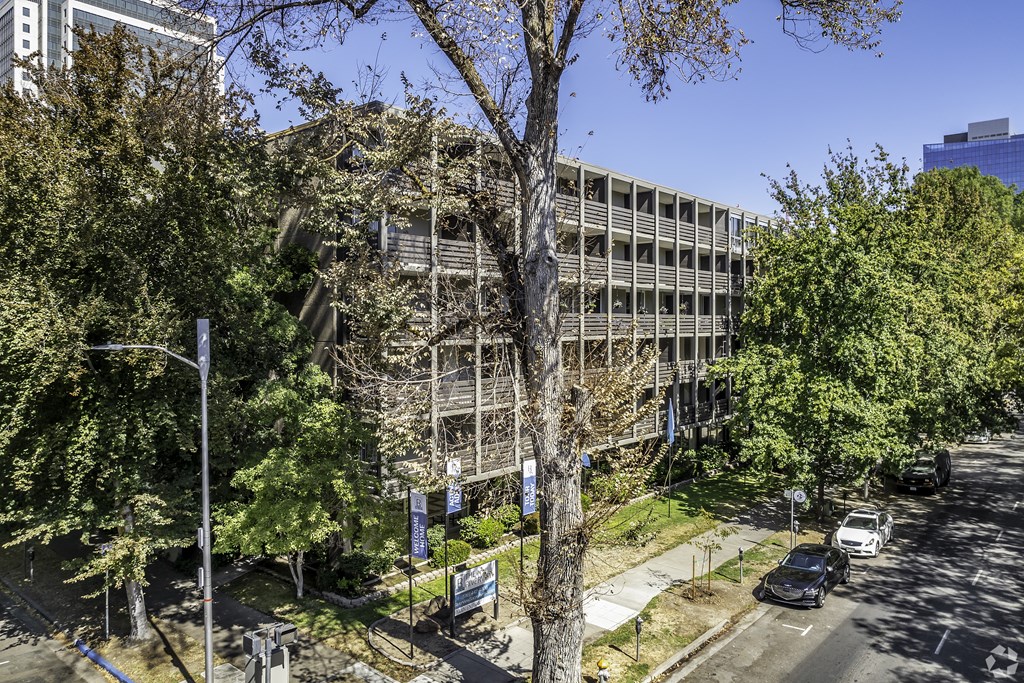 an office building with trees in front of it