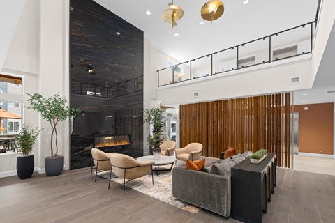 A modern living room with a fireplace and a balcony.