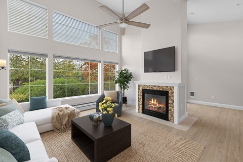 A living room with a fireplace, television, and a coffee table.