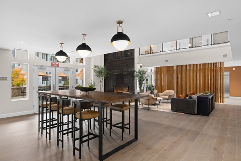 A modern dining room with a wooden table and chairs.