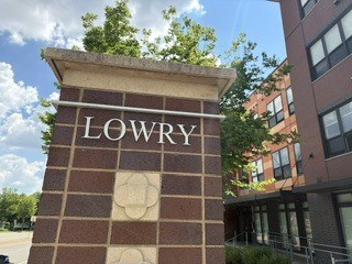 A brick pillar with the word Lowry on it.
