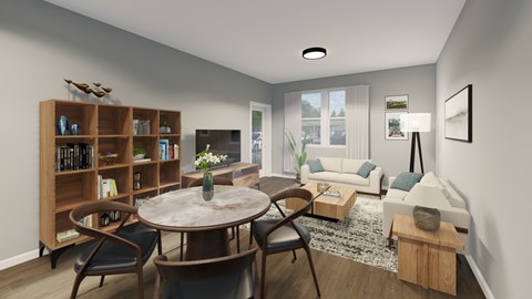 A living room with a round table and chairs, a bookshelf, and a couch.