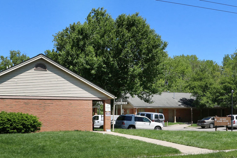 a brick building with a tree in front of it