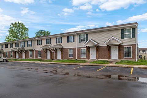 A building with a parking lot in front of it.