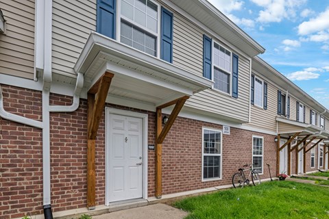 A row of houses with a bicycle leaning against the wall.