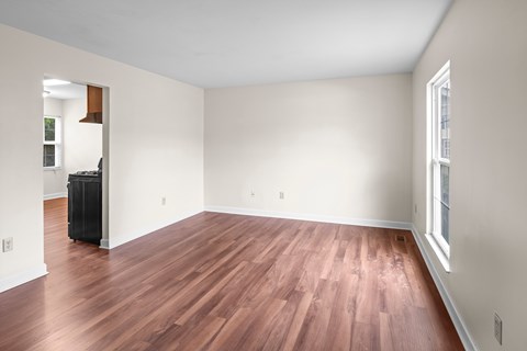 A room with wooden floors and white walls.