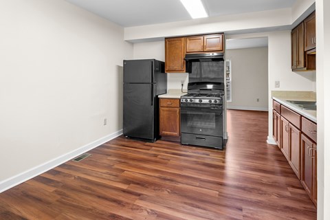 A kitchen with a black fridge and stove.