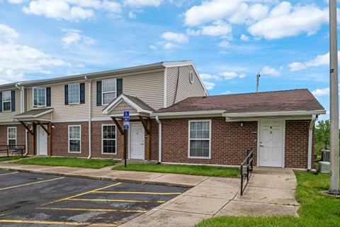 A building with a parking lot in front of it.