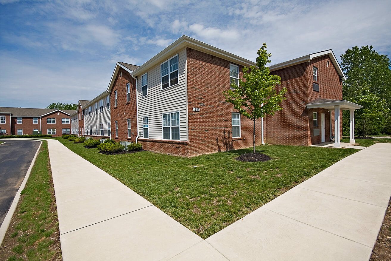A brick building with a tree in front of it.