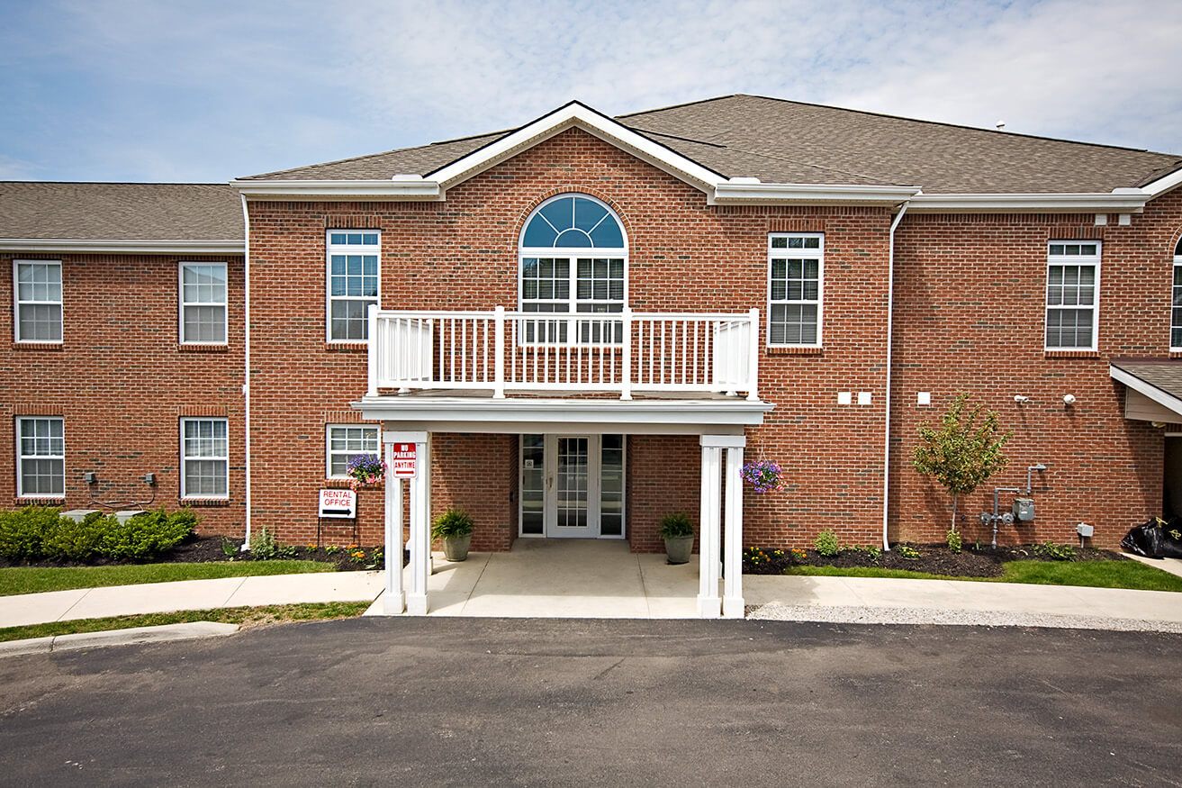 A red brick building with a white entrance.