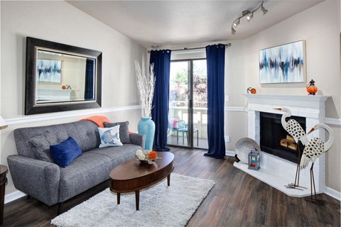 a living room with a fireplace and a couch at 2000 Lake Washington Apartments, Renton, WA