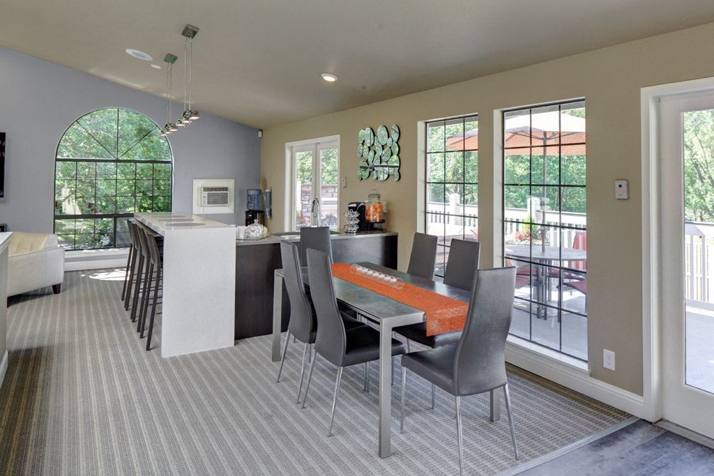 Resident clubhouse with long community table and hightop bar seating at 2000 Lake Washington Apartments, Renton, 98056