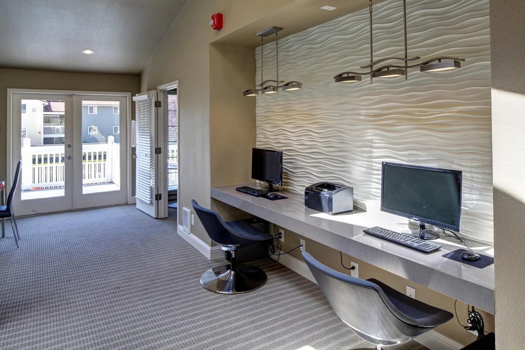 Resident business center with a desk with two computers and chairs at 2000 Lake Washington Apartments, Washington, 98056