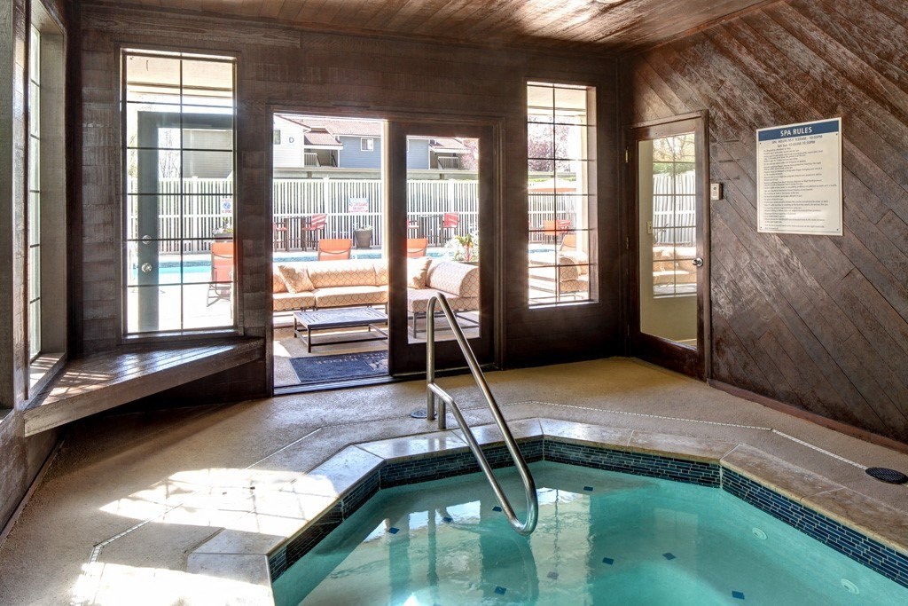 an indoor spa with a door to the outdoor pool area at 2000 Lake Washington Apartments, Renton, WA, 98056