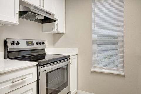 a kitchen with a stove and a window at 2000 Lake Washington Apartments, Renton, Washington