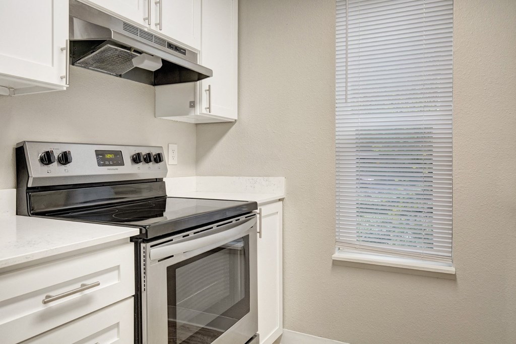 a kitchen with a stove and a window a kitchen with a stove and a window at 2000 Lake Washington Apartments, Renton, Washington
