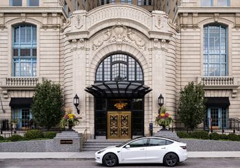 a white car parked in front of a building  at The Belden Stratford, Chicago, IL