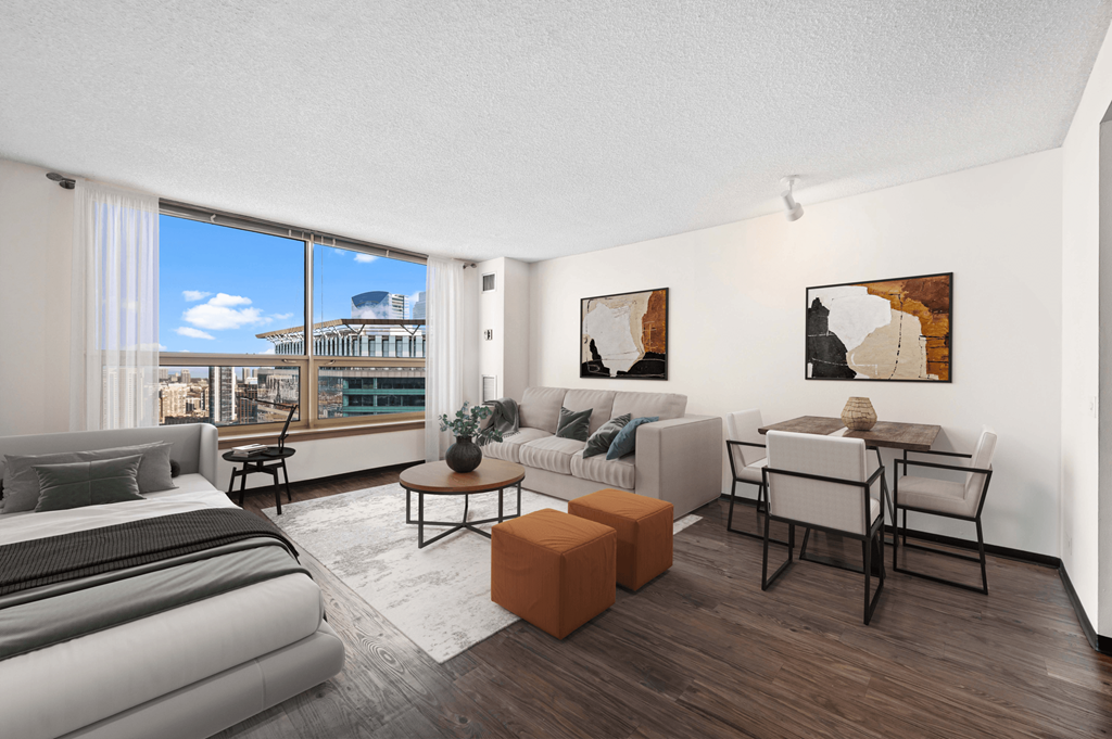 a living room with a couch and a table and a large window at Presidential Towers, Chicago, IL, 60661