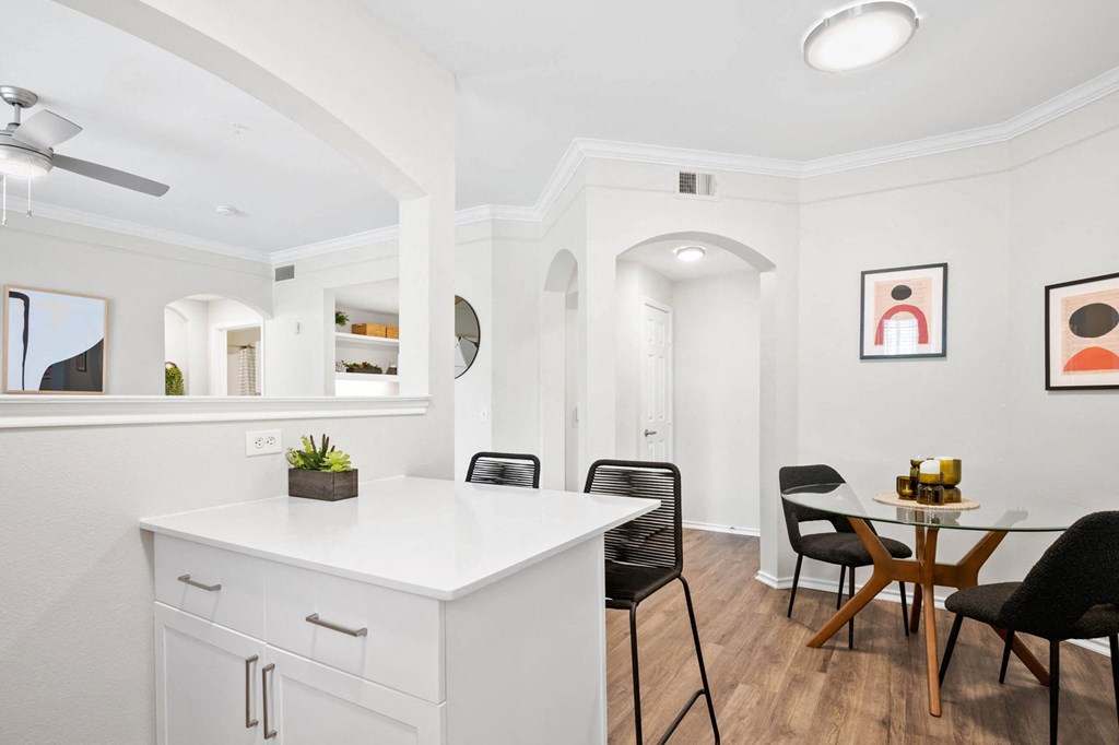 a kitchen with a white counter top and a table with chairs at Mission Gate, Texas, 75024