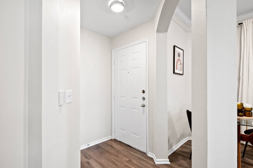 a hallway with a white door and white walls and a door to a closet at Mission Gate, Plano, TX, 75024