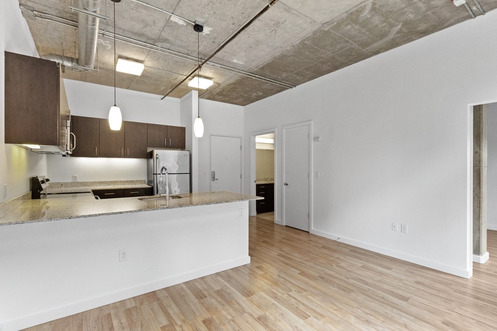 an open kitchen and living room with a kitchen counter top at The Parker Apartments, Oregon