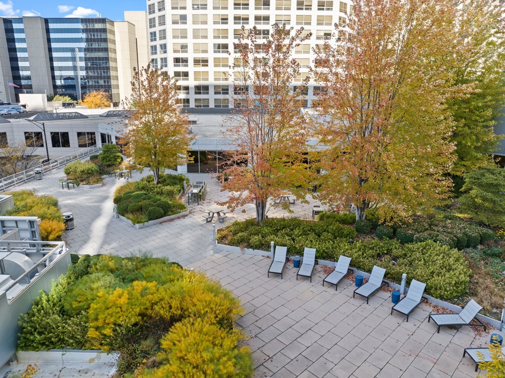 a park with benches and trees in front of a building at Presidential Towers, Chicago, 60661