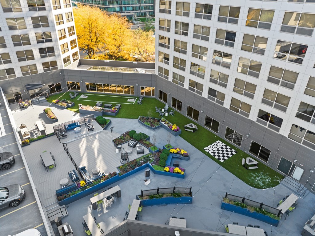 an aerial view of the courtyard of an office building with green grass and a playground at Presidential Towers, Chicago, Illinois