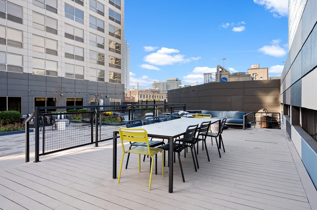 a patio with a table and chairs on top of a building at Presidential Towers, Illinois