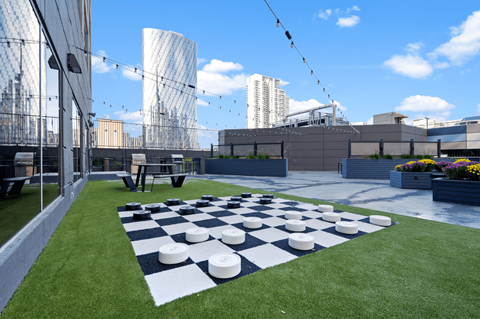 a chess board on a lawn on the roof of a building at Presidential Towers, Illinois