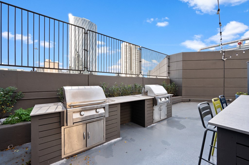 a patio with a grill and a table with chairs on it at Presidential Towers, Chicago, IL