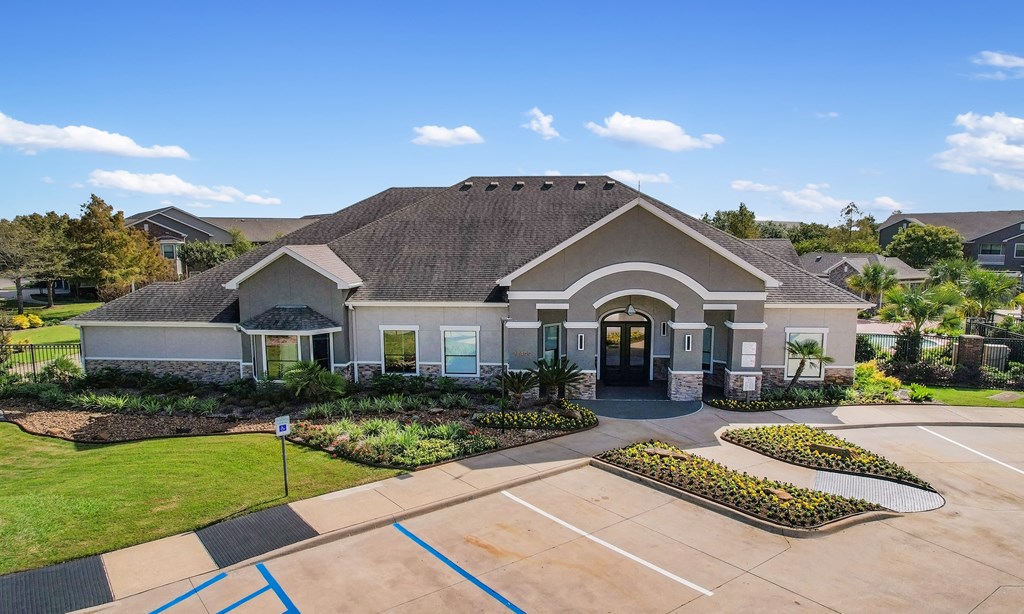 the front of a house with a driveway and a tennis court at Sladestone Shadow Creek, Pearland, TX