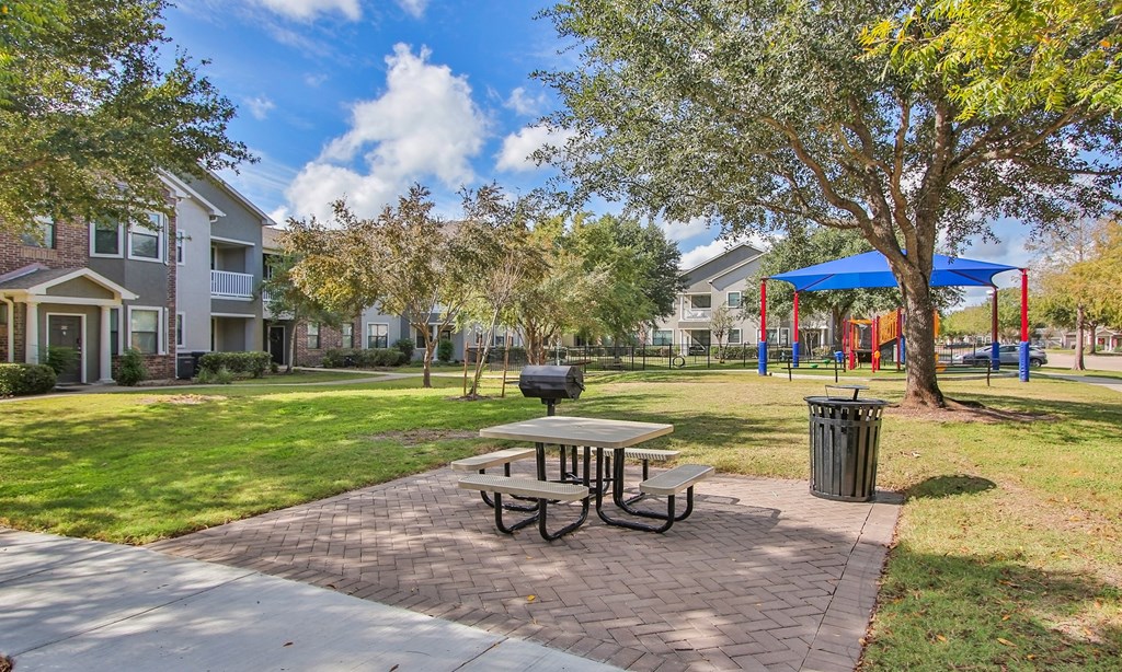 our apartments have a picnic table and a playground at Sladestone Shadow Creek, Pearland, TX, 77584