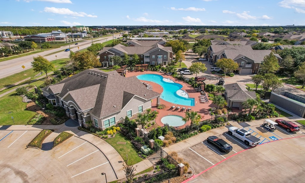 an aerial view of a neighborhood with a swimming pool and houses at Sladestone Shadow Creek, Texas
