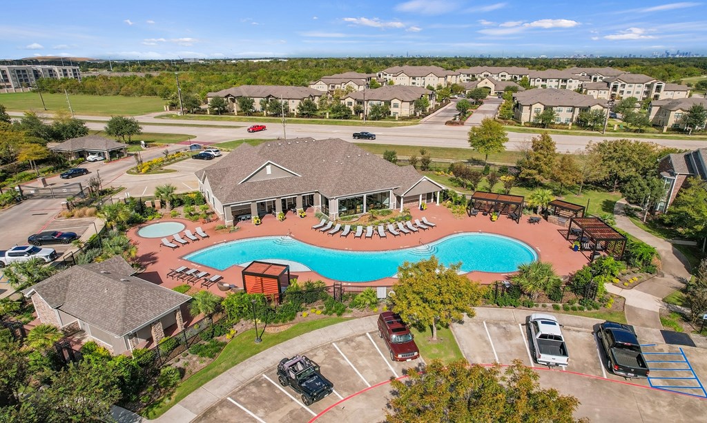 an aerial view of a swimming pool in a community with houses at Sladestone Shadow Creek, Pearland