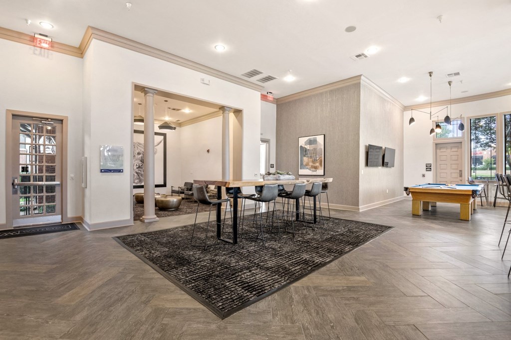 Welcoming space in the resident clubhouse with dining room table and pool table at Mission Gate, Plano, 75024