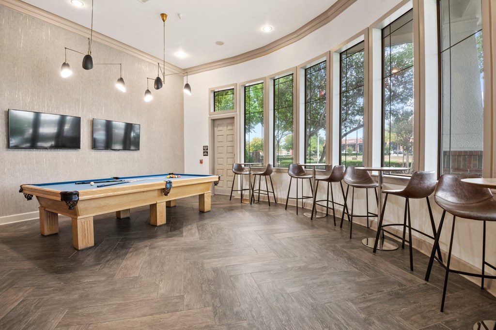 Ample seating in the lounge with a pool table at Mission Gate in Plano TX