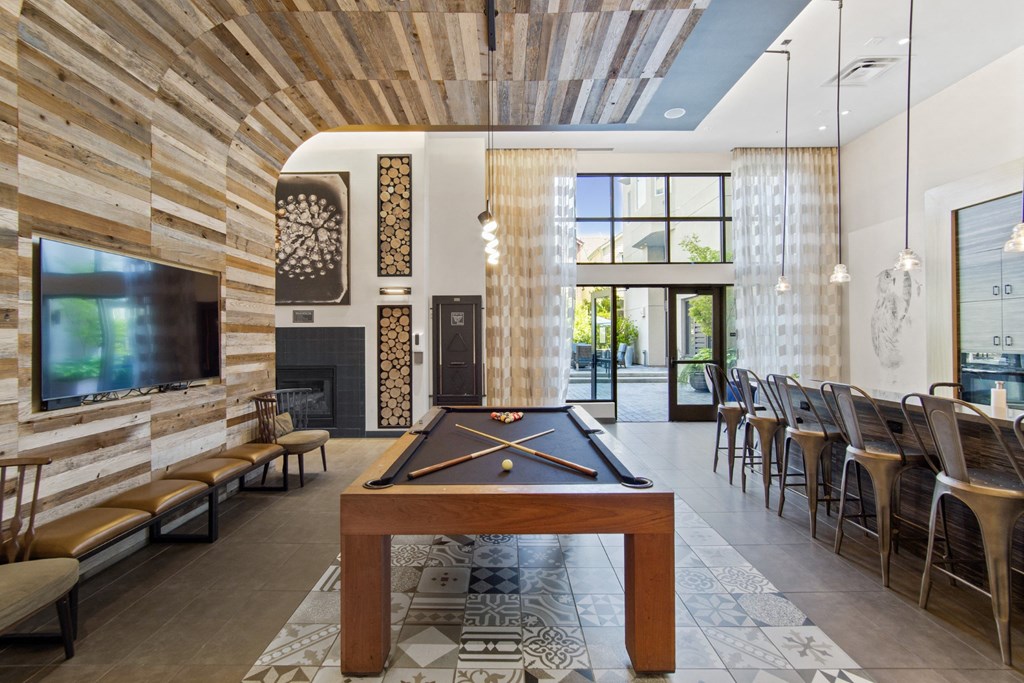 Common Area with Pool Table, Kitchen and Seating at Aventine Apartments in Hercules, CA 94547