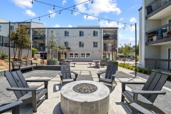 A patio with black chairs and a fire pit in front of a building at Delphine on Diamond, San Francisco, CA