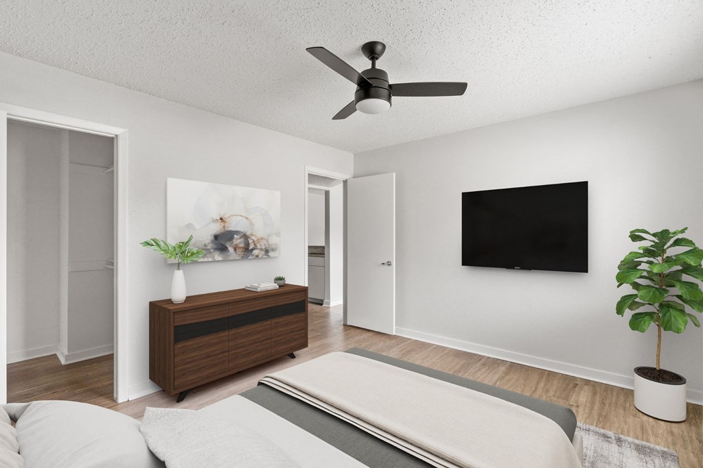 a bedroom with a ceiling fan, a bed and a TV at South Lamar Village, Austin, 78704