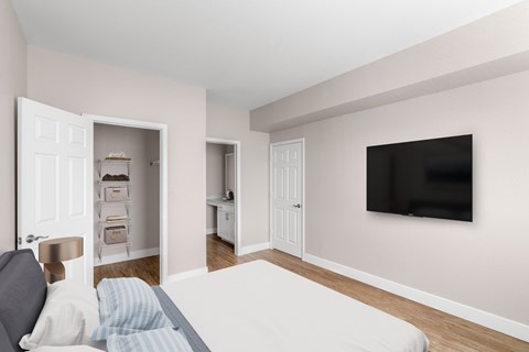 a bedroom with a bed and a tv on the wall at Plum Creek in Castle Rock, CO