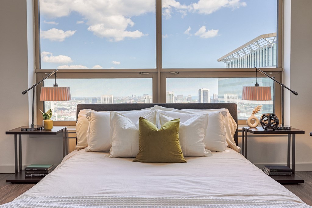 a bedroom with a large bed in front of a window