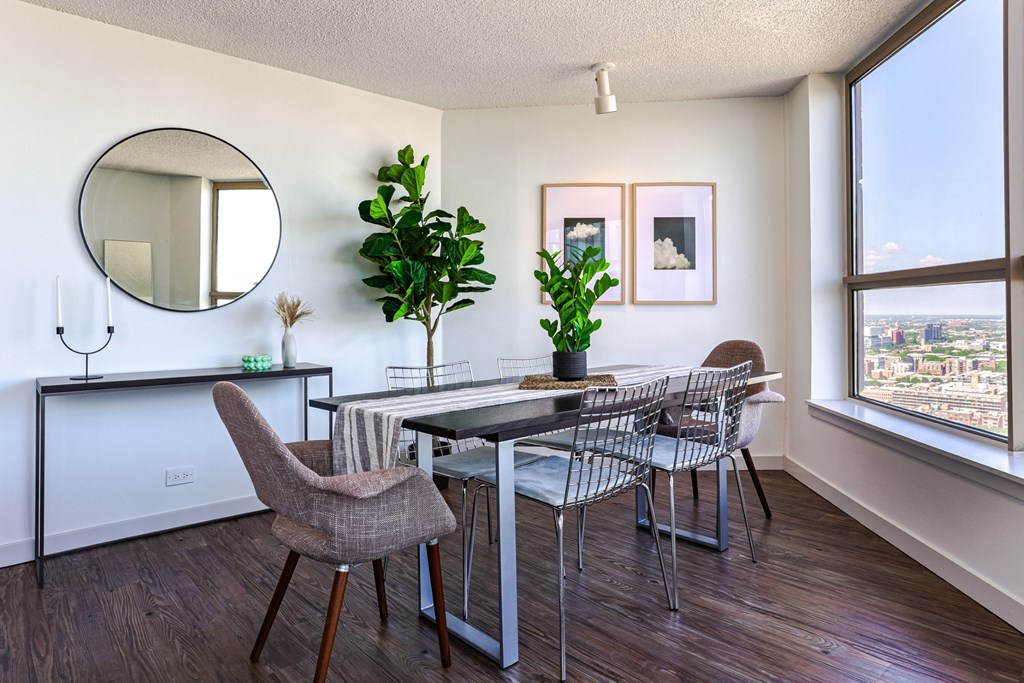 a dining room with a table and chairs and a large window